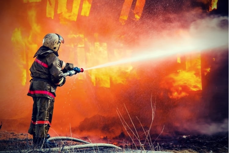 Fireman extinguishes a fire Fireman extinguishes a fire