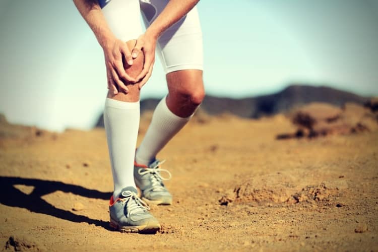 Running injury - male runner with knee pain